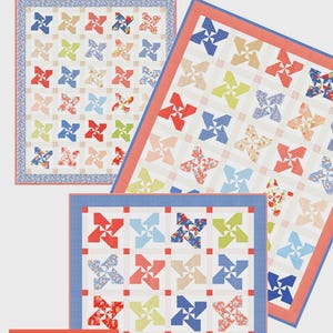 May include: Three quilts with a pinwheel pattern in red, blue, green, and pink floral fabrics. The quilts are displayed on a white background. The text "Pinwheel Parade" is at the top, and "THREE SIZES & THREE PRECUTS!" is at the bottom.