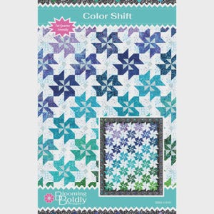 May include: A quilt pattern titled "Color Shift" featuring a repeating pinwheel design in shades of blue, teal, and purple. The pattern is labeled "Fat Quarter Friendly" and includes a smaller, framed version of the quilt design.