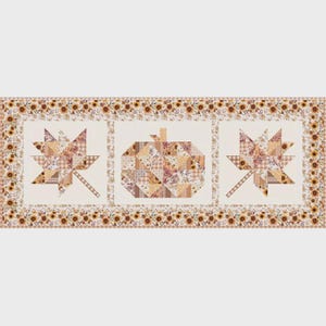 May include: A rectangular table runner featuring a patchwork design with three central panels. The outer panels display maple leaf shapes, while the center panel shows a pumpkin. The border is decorated with a repeating sunflower pattern.