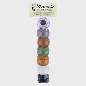 May include: A stack of colorful thread spools in shades of purple, gray, brown, green, gold, white, and black. The spools are labeled "Presencia America" and "Tuxedo Tales Sampler."