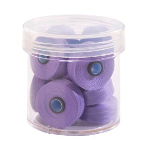 May include: A clear plastic container filled with multiple spools of lavender-colored thread.