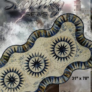 May include: A quilted fabric with a wavy design, featuring three large starburst patterns in navy blue. The border has a blue and tan geometric pattern. The dimensions are 31 inches by 78 inches.