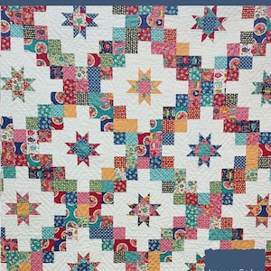 May include: A colorful quilt pattern featuring a ladder design with star accents. The quilt is made with various fabric patterns in red, blue, orange, and green. The finished quilt size is 50" x 70". The text "Layer Cake Ladder Quilt Pattern" is visible.