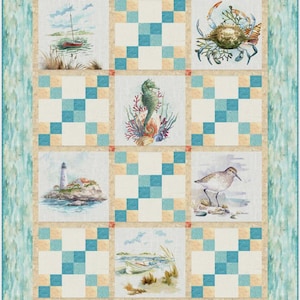 May include: A quilt pattern titled "Lighthouses and Boats" featuring watercolor illustrations of coastal scenes. The design includes images of a lighthouse, boats, a crab, a seahorse, and a shorebird. The quilt measures 50 inches by 63 inches.