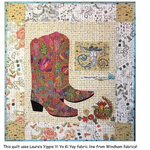 May include: A colorful quilt titled "Her Boots" features a pair of cowboy boots with floral and paisley designs. The quilt is 33 inches wide and 38 inches high, with a background of various patterned fabrics. The quilt includes the text "Her Boots" and "By Laura Heine".