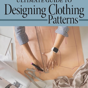 May include: An overhead shot of a person's hands working on a clothing pattern. The image features a sewing machine, measuring tape, and fabric. The text on the book reads "Ultimate Guide to Designing Clothing Patterns" by Suzy Furrer.