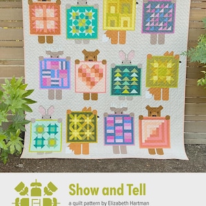 May include: A handmade quilt featuring whimsical animal figures holding colorful geometric designs. The quilt showcases a variety of colors, including pink, blue, yellow, and green, with a cream-colored background. The text "Show and Tell" is visible.