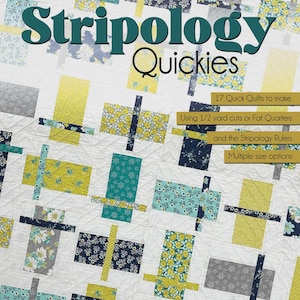May include: A white quilt with a patchwork design featuring rectangular and cross-shaped blocks in shades of yellow, teal, gray, and navy blue floral patterns. The quilt has the text "Stripology Quickies" and "17 Quick Quilts to make".