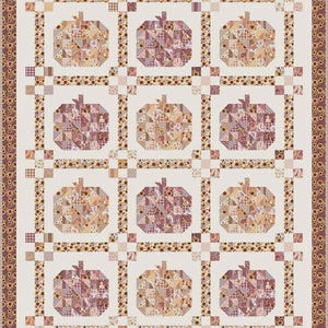 May include: A rectangular quilt featuring a grid of twelve pumpkin blocks in shades of pink, brown, and cream. Each pumpkin is constructed from small patchwork squares. The quilt is framed by a border of sunflowers and a solid cream background.