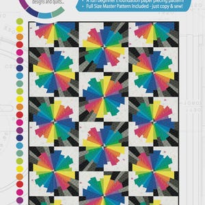 May include: A colorful quilt pattern featuring a repeating design of rainbow-colored spokes radiating from a central point. The pattern is set against a black and white checkered background. The text "COLOUR TWIST" is visible.