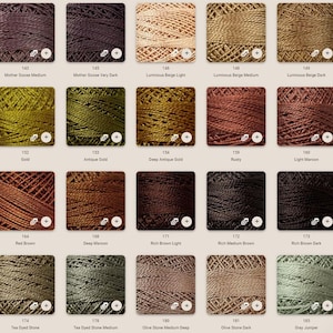 May include: A color chart of DMC embroidery floss, showing 20 different shades of brown, beige, green, and gold. The floss is wound on spools and labeled with their corresponding DMC numbers.