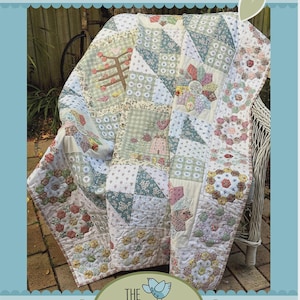 May include: A handmade quilt with a patchwork design. The quilt features various floral and geometric patterns in pastel colors, including pink, green, and white. The text "LIGHT & SHADE" is at the top, and the logo for "The Birdhouse Patchwork Designs" is at the bottom.
