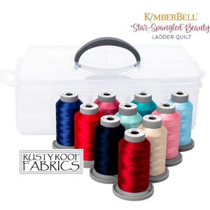 May include: A set of 10 spools of embroidery thread in various colors, including red, blue, pink, and teal. The spools are arranged in a clear plastic storage container with a gray handle. The label on the container reads "Kimberbell *Star-Spangled* Beauty Ladder Quilt".