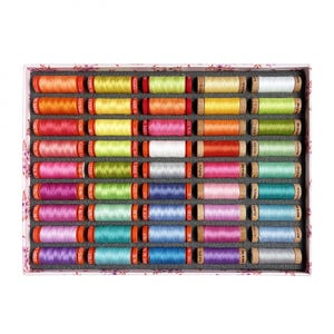 May include: A box of colorful thread spools in various shades of orange, yellow, pink, green, blue, and purple. The spools are neatly arranged in rows within a decorative box, perfect for sewing and crafting projects.