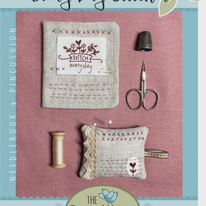May include: A collection of sewing tools and accessories, including a needlebook, thimble, scissors, pin cushion, and thread spool. The needlebook features embroidered text that reads "STITCH everyday". The image is set against a pink background with the text "Every Day Stitcher".