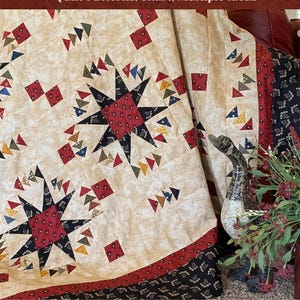 May include: A cream-colored quilt with a star pattern and red, black, and blue accents. The quilt features the text "OPTION 5 - THE HENHOUSE BLOCK" and "Quilt Patterns, Chart, Multiple Ideas". The quilt is designed by Jodi Barrows.