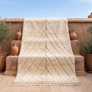 May include: A set of three ceramic mugs with a speckled, matte finish. Each mug features a different color: light blue, cream, and gray. The mugs have a simple, modern design, suitable for coffee or tea.