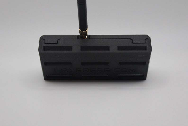 May include: Black plastic case with a gold antenna and the text "LAYERFIRE.COM" printed on the front.