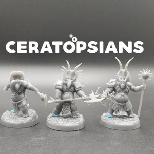 May include: Three gray, 3D printed miniature figurines of Ceratopsians, a type of dinosaur, with a tribal theme. The figures are posed in a standing position and are holding weapons. The figures are on a white background.