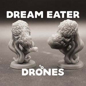 May include: Two gray 3D printed miniature figures of a creature called a "Dream Eater" with the text "DRONES" below. The figures have a textured, organic appearance with multiple tentacles and eyes.