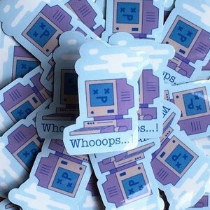 May include: A stack of blue and purple computer stickers with a cloud design and the text "Whooops... 3... ! ps... !"