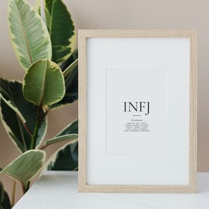 May include: A framed print with the text "INFJ - The Advocate" and a list of personality traits: "Observant - Lone - Intense - Quiet - Idealistic - Insightful - Authentic -  Idealistic - Logical - Empathetic - Private - Independent -  Devoted".
