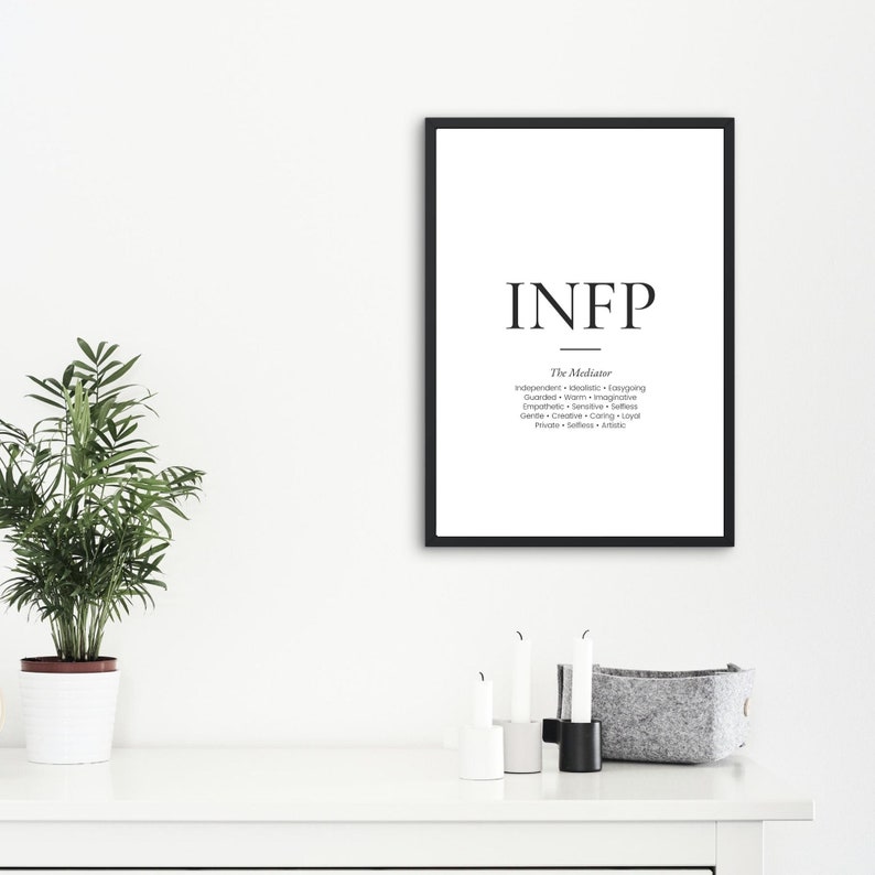 May include: A framed print with the letters "INFP" in a minimalist style. Below the letters, the text "The Mediator" is displayed, followed by a list of descriptive words. The frame is black, and the background is white.