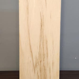 Puede incluir: Una tabla de madera lisa de color marr&oacute;n claro. La tabla est&aacute; hecha de madera contrachapada y tiene un patr&oacute;n de veta de madera natural.
