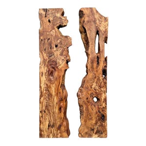May include: Two vertical, raw-edge wooden slabs with a natural, organic appearance. The wood has a rich, warm brown color with intricate grain patterns and knots. The slabs have irregular shapes and are ideal for a rustic or natural decor theme.