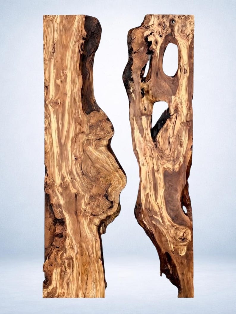 May include: Two vertical wooden slabs with a natural, organic aesthetic. The wood features a mix of light and dark brown tones, with intricate grain patterns and unique, irregular shapes. The slabs have a raw, unfinished appearance, showcasing the natural beauty of the wood.