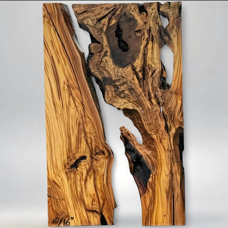 May include: A two-piece wooden wall art piece with a natural, organic design. The wood features rich brown and tan tones with dark, contrasting knots and grain patterns. The pieces are separated by a white space, and the bottom left corner has the text "10/16".