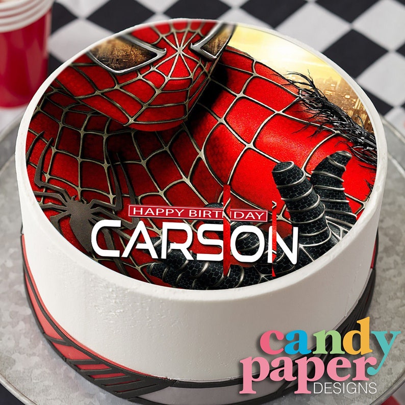 May include: A round edible cake topper featuring a red and black Spiderman image with the text "HAPPY BIRTHDAY CARSON".
