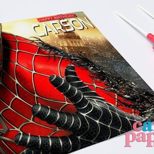 May include: A red and black Spiderman birthday card with the text "Happy Birthday Carson" on the front.
