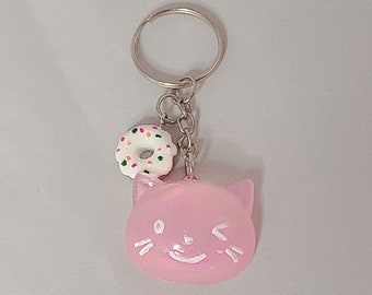 pink winking cat keychain with donut charm