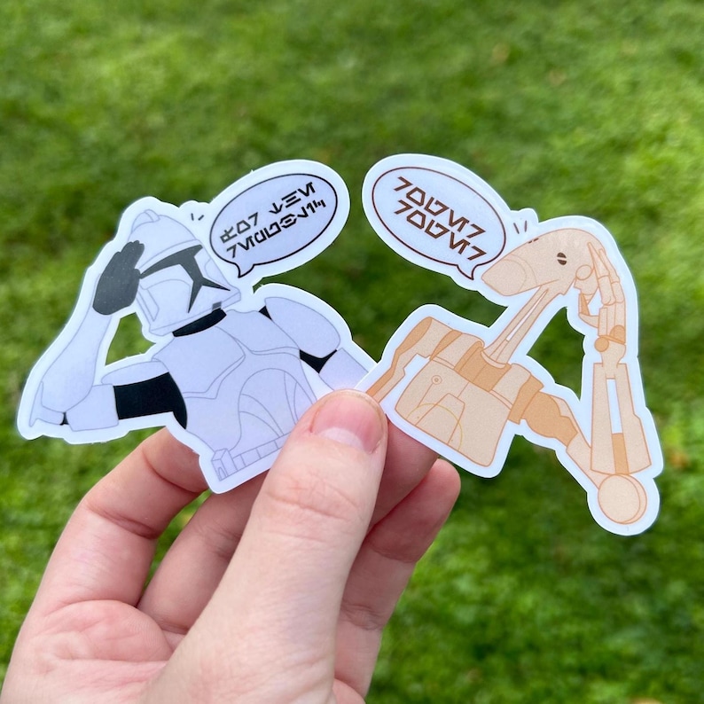 May include: Two Star Wars character stickers. A white and black clone trooper salutes with the text "7/10 would bang" above his head. A tan droid with a long neck and arms is looking up with the text "700/10" above its head.