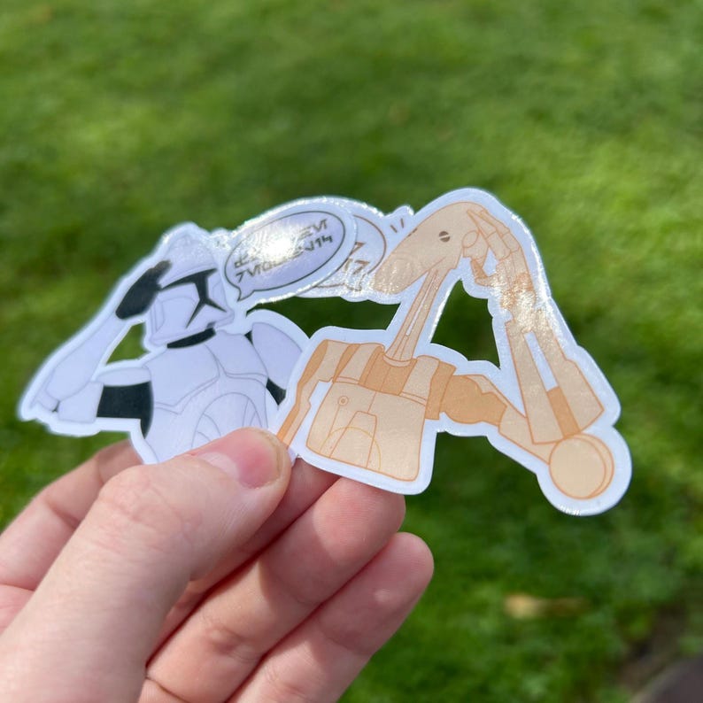 May include: Two Star Wars character stickers. A white and black Stormtrooper sticker with a speech bubble that says "I'm a good guy". A beige and brown sticker of a character from the Star Wars universe with a confused expression.