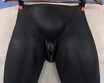 May include: Black rubber shorts with a cutout in the front.