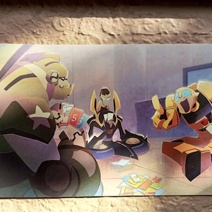 May include: A vibrant illustration shows three cartoon figures engaged in a card game. The characters are rendered in yellow, brown, and purple hues. A collection of cards is strewn on the floor. The artwork has a lively, animated aesthetic.