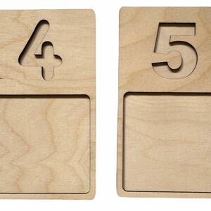 May include: Two wooden number plaques with a cutout of the numbers 4 and 5. Each plaque has a blank space below the number.