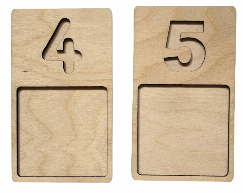 May include: Two wooden number plaques with a cutout of the numbers 4 and 5. Each plaque has a blank space below the number.