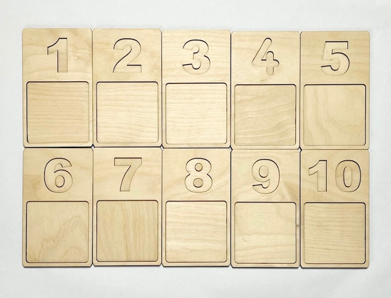 May include: Ten wooden tiles with numbers 1 through 10 printed on them. Each tile has a blank space below the number.