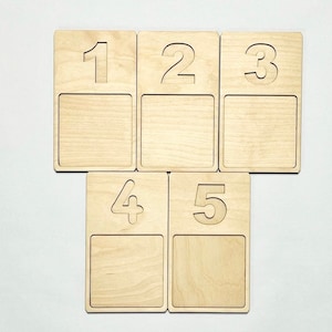 May include: Five wooden squares with numbers 1 to 5 cut out. Each square has a blank space below the number.