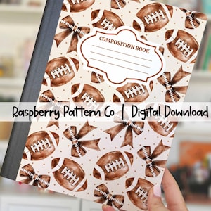 May include: A composition notebook cover featuring a repeating pattern of watercolor footballs and bows on a cream background. The cover includes the text "Printable Composition Notebook Cover" and "COMPOSITION BOOK". The notebook is held by a person.