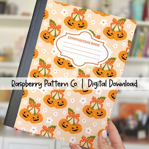 May include: A composition notebook cover with a pumpkin pattern. The cover features smiling jack-o'-lanterns with orange bows and white flowers on a peach background. The text "Printable Composition Notebook Cover" and "Raspberry Pattern Co | Digital Download" are visible.