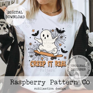May include: White t-shirt featuring a cartoon ghost riding a skateboard, with bats, stars, and spiderwebs. The text "Creep It Real" is printed below the graphic. "Digital Download" is printed at the top left.