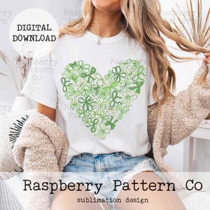 May include: A white t-shirt with a green and yellow heart-shaped design made of bows. The text "DIGITAL DOWNLOAD" is in a white box on the top left corner of the image. The text "Raspberry Pattern Co" is at the bottom of the image with the text "sublimation design" below it.
