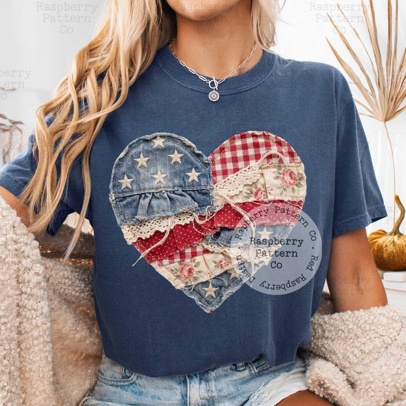 K&ouml;nnte beinhalten: Marineblaues T-Shirt mit einem Patchwork-Herz-Design. Das Herz besteht aus Jeansstoff, rot-wei&szlig;em Vichy, floralen und gepunkteten Stoffen mit Spitzendetails. Das Design enth&auml;lt Sterne und patriotische Farben.