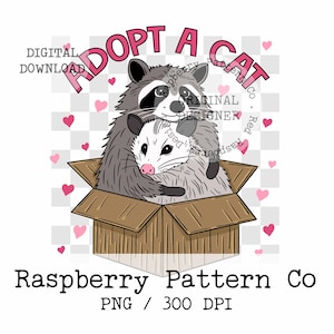 Op de afbeelding: Adopt a Cat afbeelding met een wasbeer en een opossum die elkaar knuffelen in een kartonnen doos. De tekst "Adopt a Cat" staat in roze letters met hartjes rondom de afbeelding. De tekst "Raspberry Pattern Co. PNG / 300 DPI" staat onderaan de afbeelding.