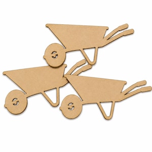 May include: Three flat, tan-coloured wooden cutouts shaped like wheelbarrows. Each cutout features a simple, stylised design with a single circular wheel, a deep basin, two handles, and a support leg, all rendered in a uniform, light brown material.