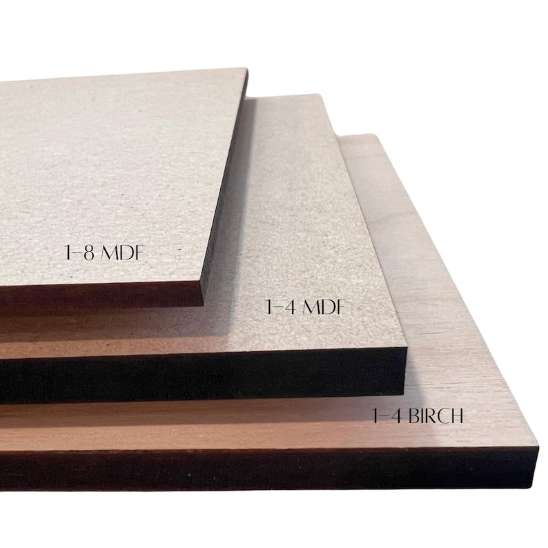 May include: Three rectangular wood boards of varying thicknesses are stacked. The top board is labeled "1-8 MDF", the middle board is labeled "1-4 MDF", and the bottom board is labeled "1-4 BIRCH". The boards are light brown and beige.